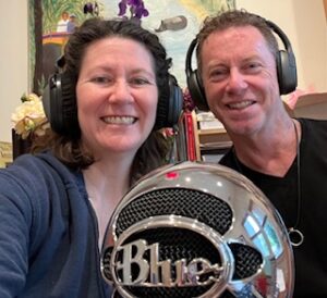 Sarah and Ian in front of a large microphone