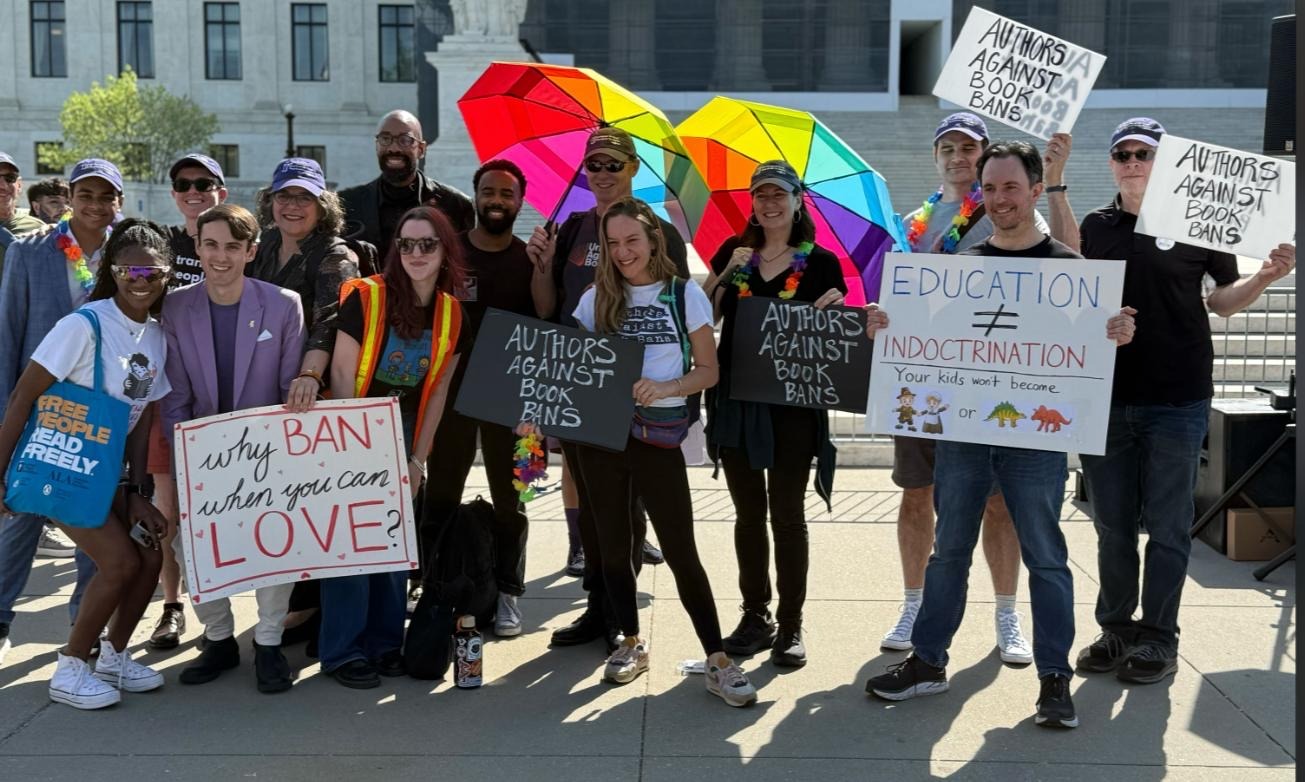 People holding signs of support outside the Supreme Court